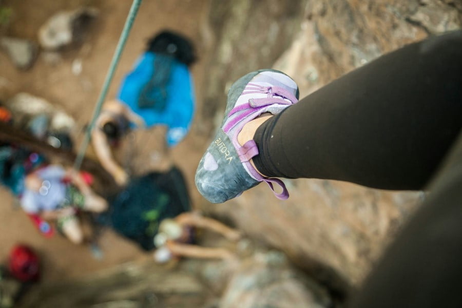 a person's foot on a rock wall