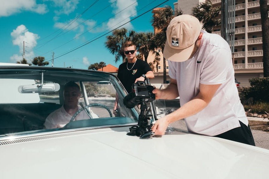 Camera Car a man holding a camera to a car