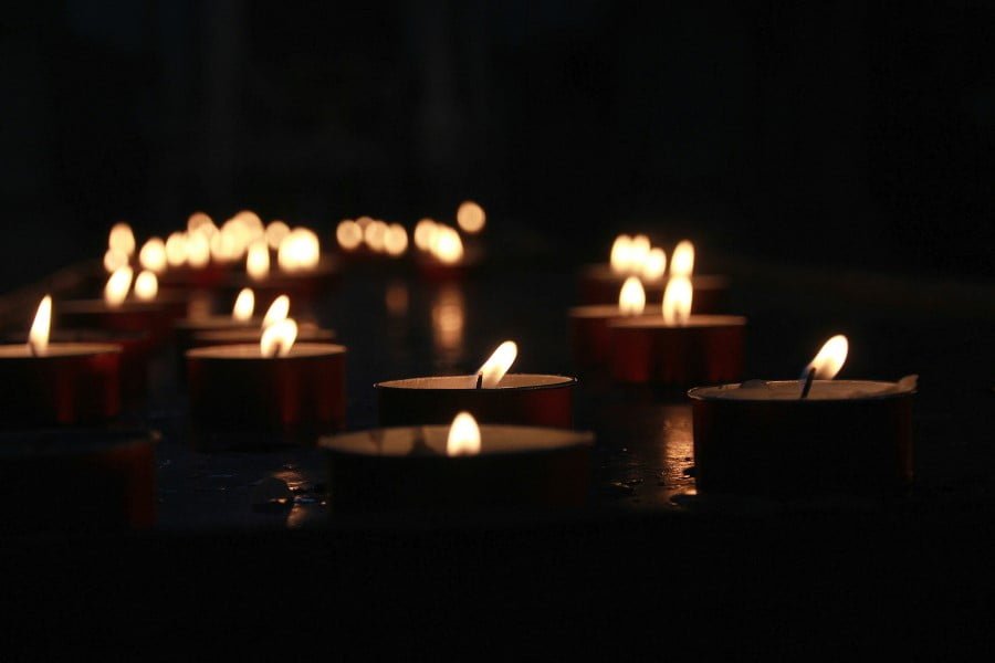 a group of candles lit up in the dark