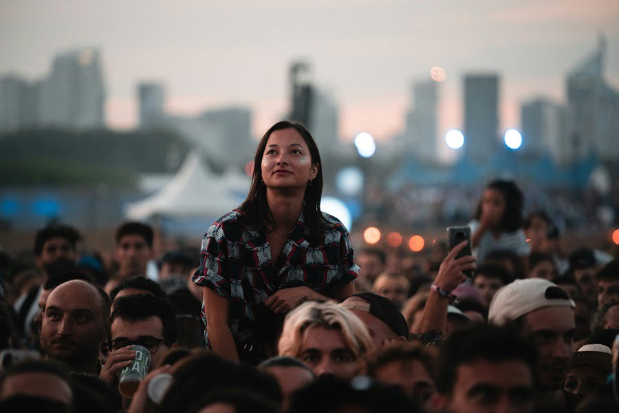 Crowd Management a woman standing on her shoulders in front of a crowd of people