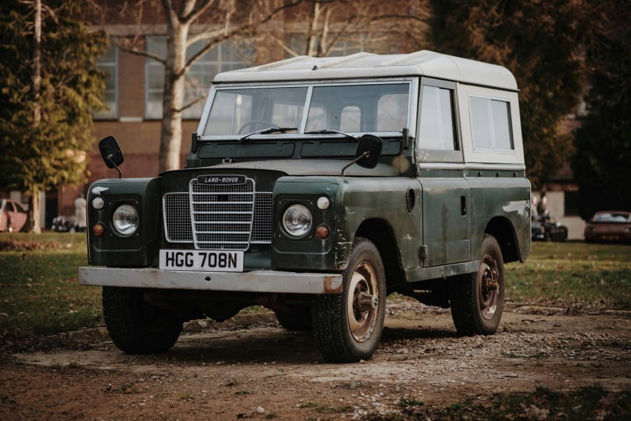 Driving UK a green and white vehicle parked on dirt
