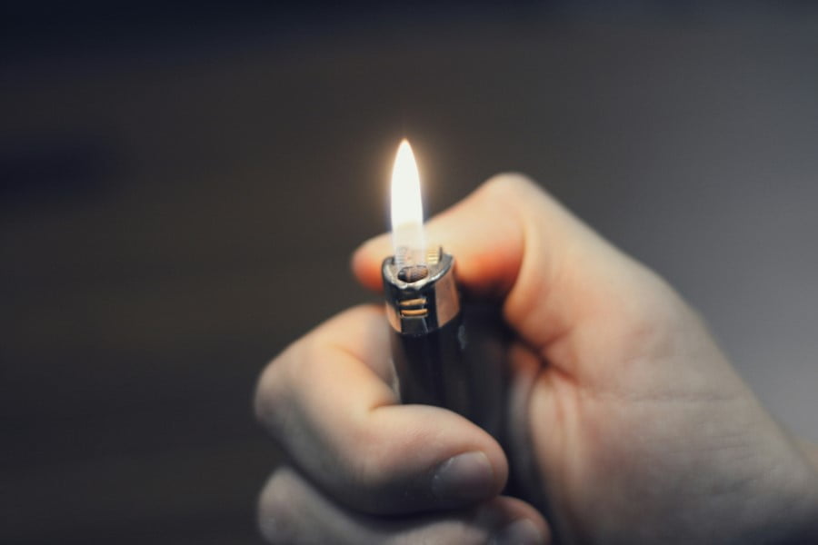 a hand holding a lighter