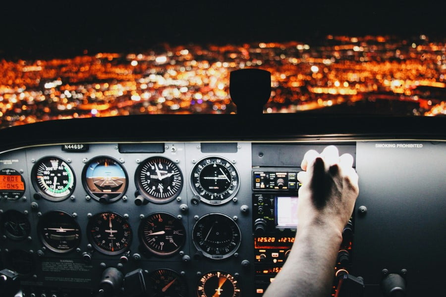 Flight Deck a hand on the control panel of a plane