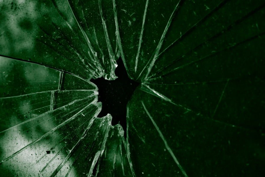 a broken glass with a hole in it