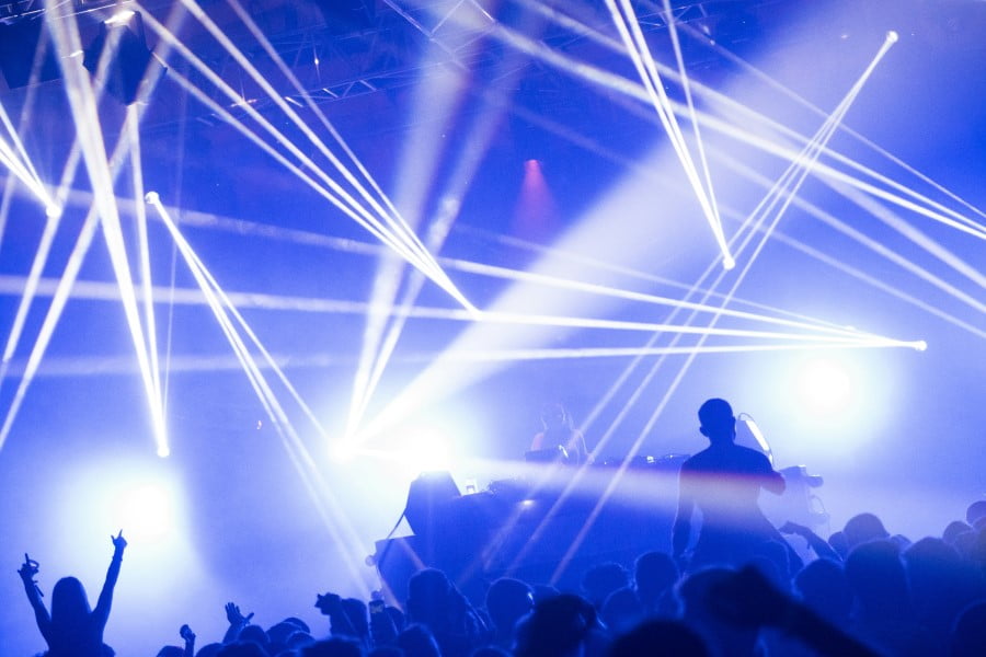 a crowd of people on a stage with bright lights