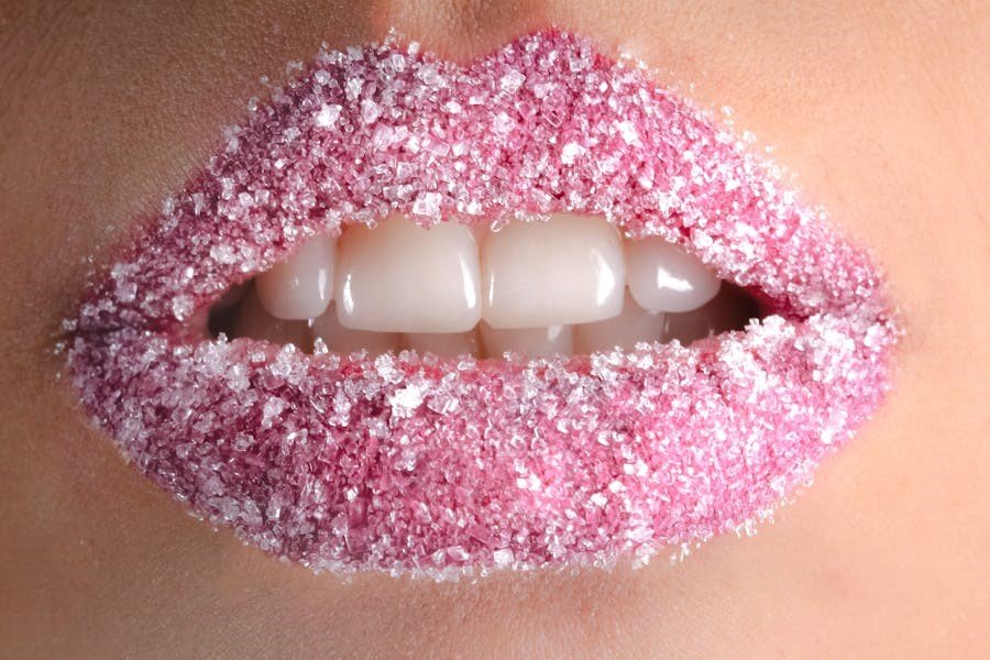 a close up of a lips with sugar on it