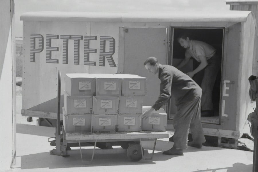 Manual Handling a man pushing a cart full of boxes