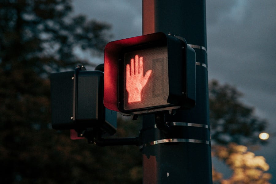 Permit a crosswalk sign with a hand symbol