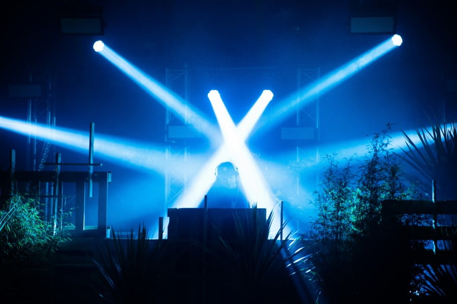 a person on a stage with blue lights
